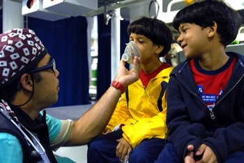 US Navy volunteer anesthesiologist prepares twin brothers from the Dominican Republic for surgery.